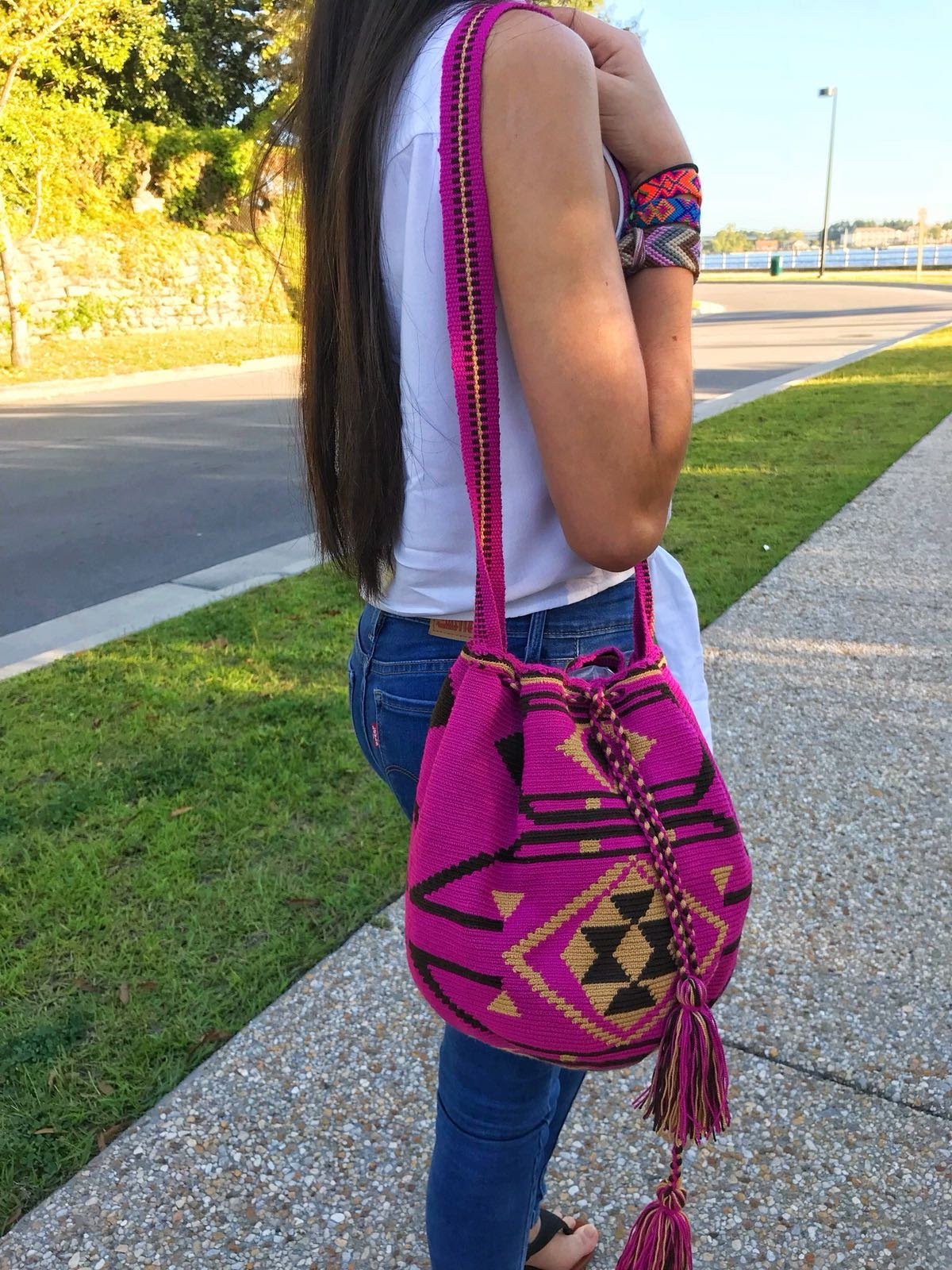 Young woman holds a beautiful one-thread Wayuu bag.